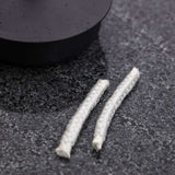 To thin white replacement wicks for SACKit Oil Lamp on a white background