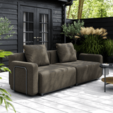 Cobana Lounge Sofa i sort med to moduler uden armlæn og puf i et udendørs miljø.
