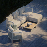 Kirra Lounge Sofa i sandfarvet med to sæder og tilhørende Kirra bord i udendørs miljø.