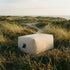 Soft Sofa Outdoor Pouf i boucle beige, blød og lav udendørs siddepouf i boucle stof.
