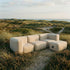 Soft Sofa Outdoor 3-personers udendørs sofa i boucle beige med tilhørende puf i samme farve.