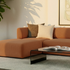Fjord Sofa Pouf i blød Cosmo Terracotta tekstil med afrundede kanter og skandinavisk design.