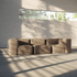 Blød indendørs sofa fra sackit med afrundede armlæn dybe hynder og fleksibelt design i varmt beige stof i et lyst moderne rum