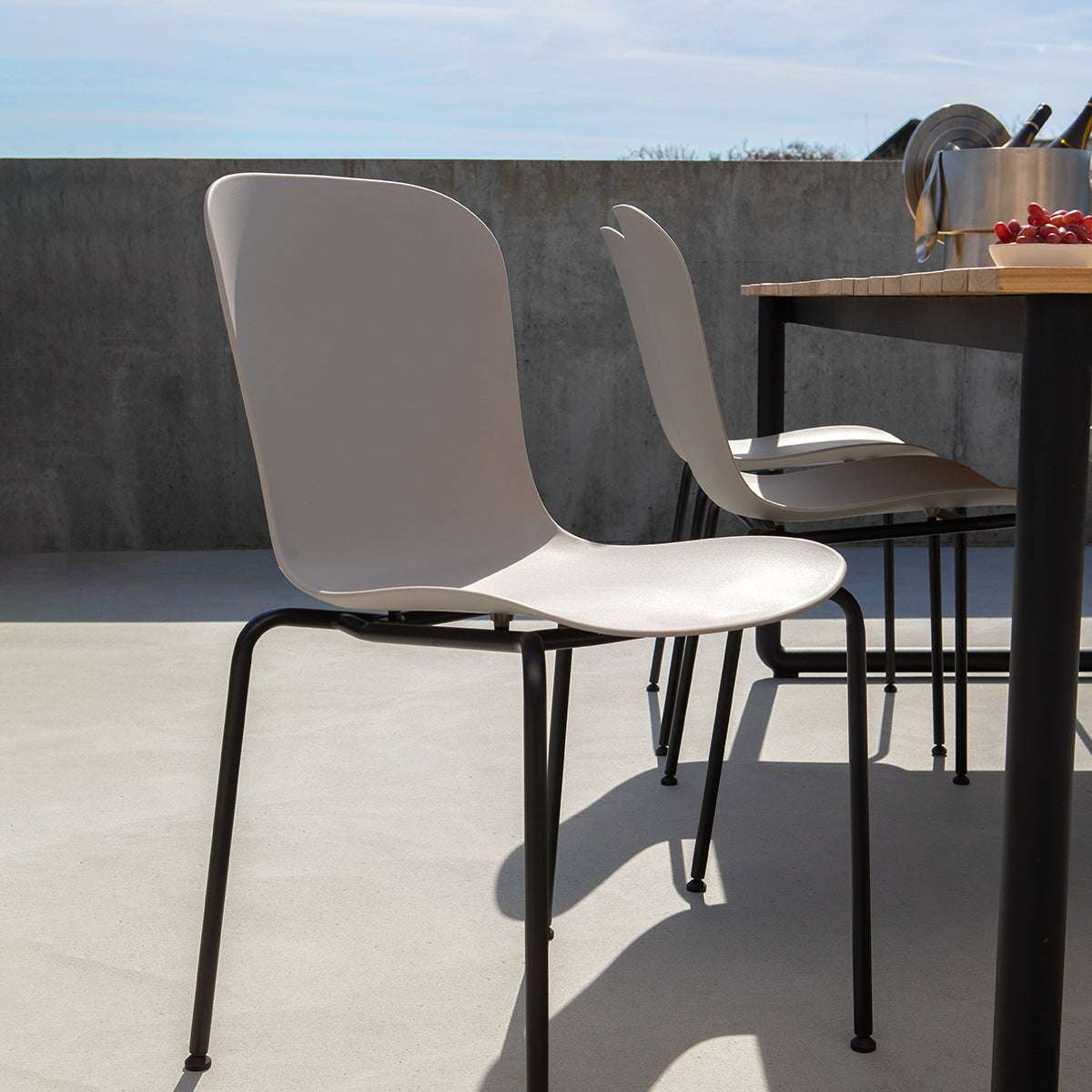 Taupe Patio Chair no. One S1 with black powder-coated steel frame on outdoor terrace setting