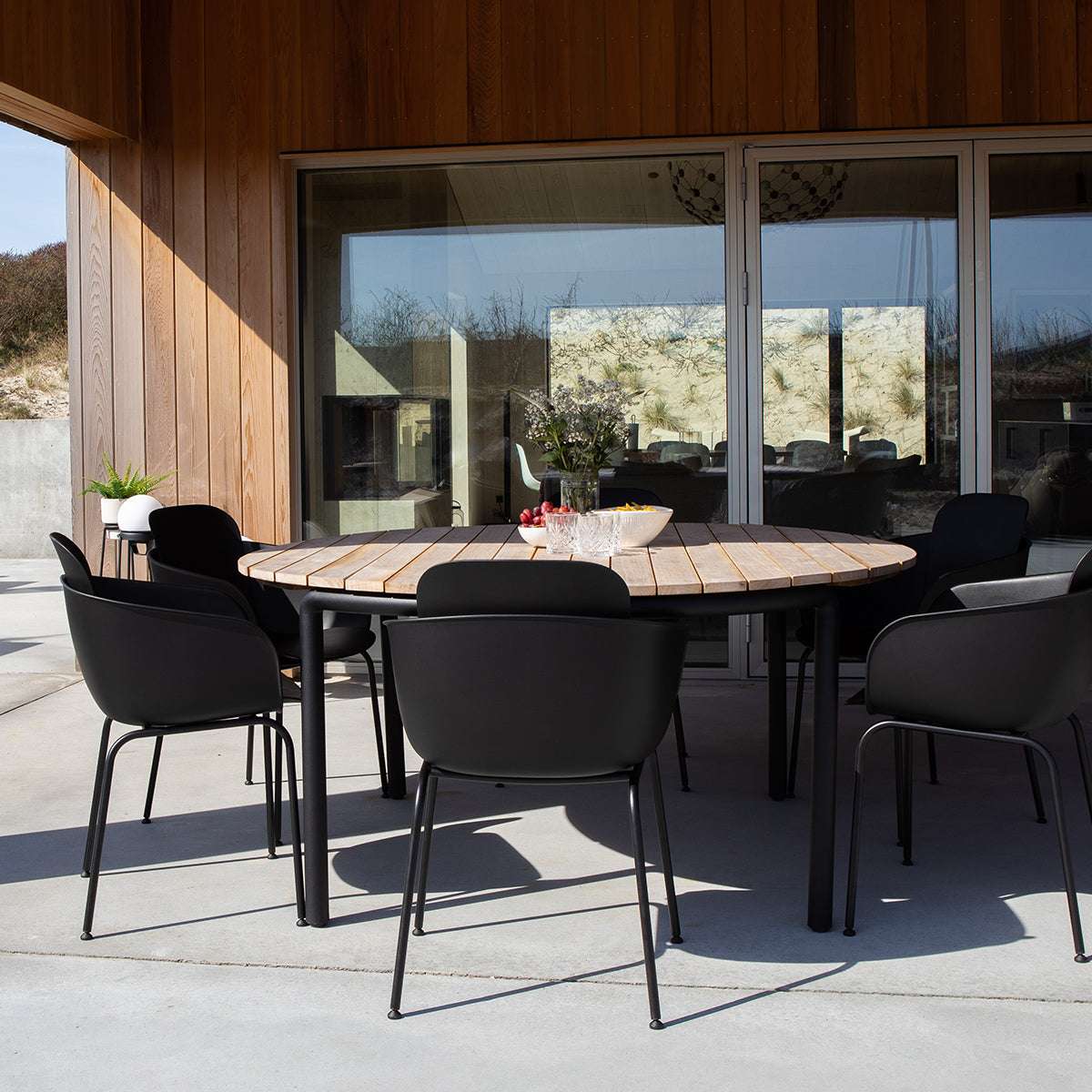 Taupe Patio Chair no. One S2 with black frame in outdoor setting