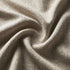 Nærbillede af beige stof med bløde folder og tæt vævning til en sackit Soft Sofa Outdoor pouf i dansk design
