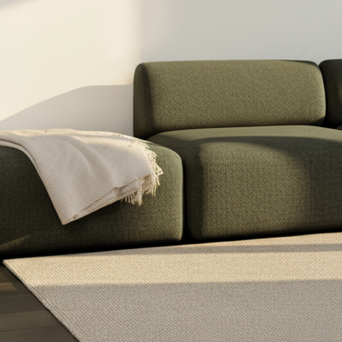 Fjord Sofa pouf i blød Cosmo Olive tekstil med afrundede kanter og skandinavisk design.