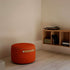 SACKit Pouf Indoor i orange Jaquard stof med rund form og lav højde, placeret i hjemmemiljø.