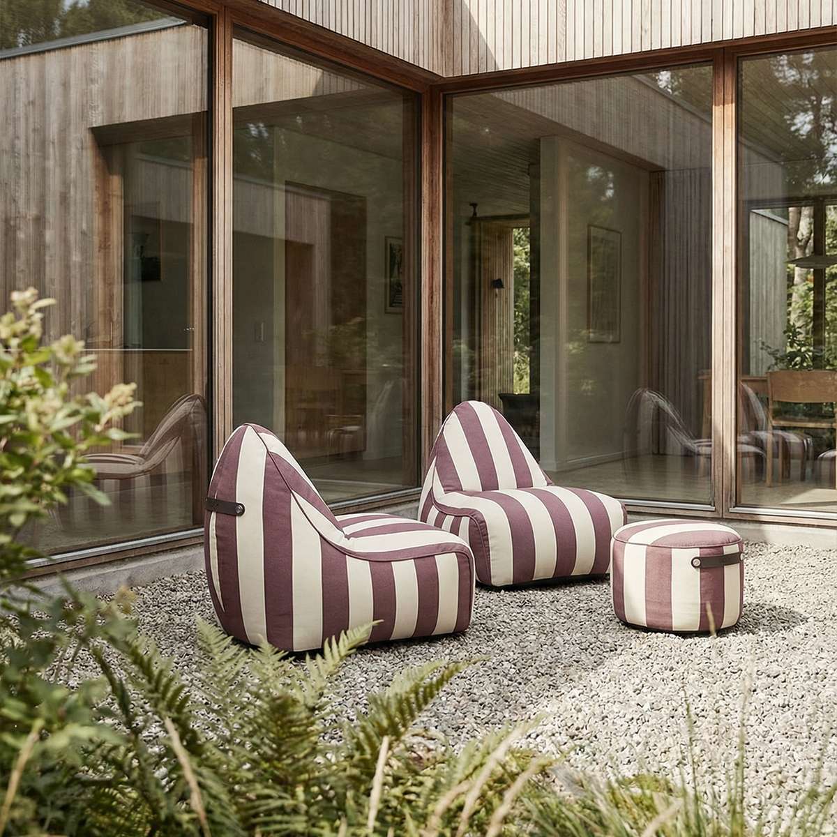 sackit udendørs loungesæt med to stribede sækkestole og matchende puf på en terrasse ved moderne træhus af SACKit Danmark